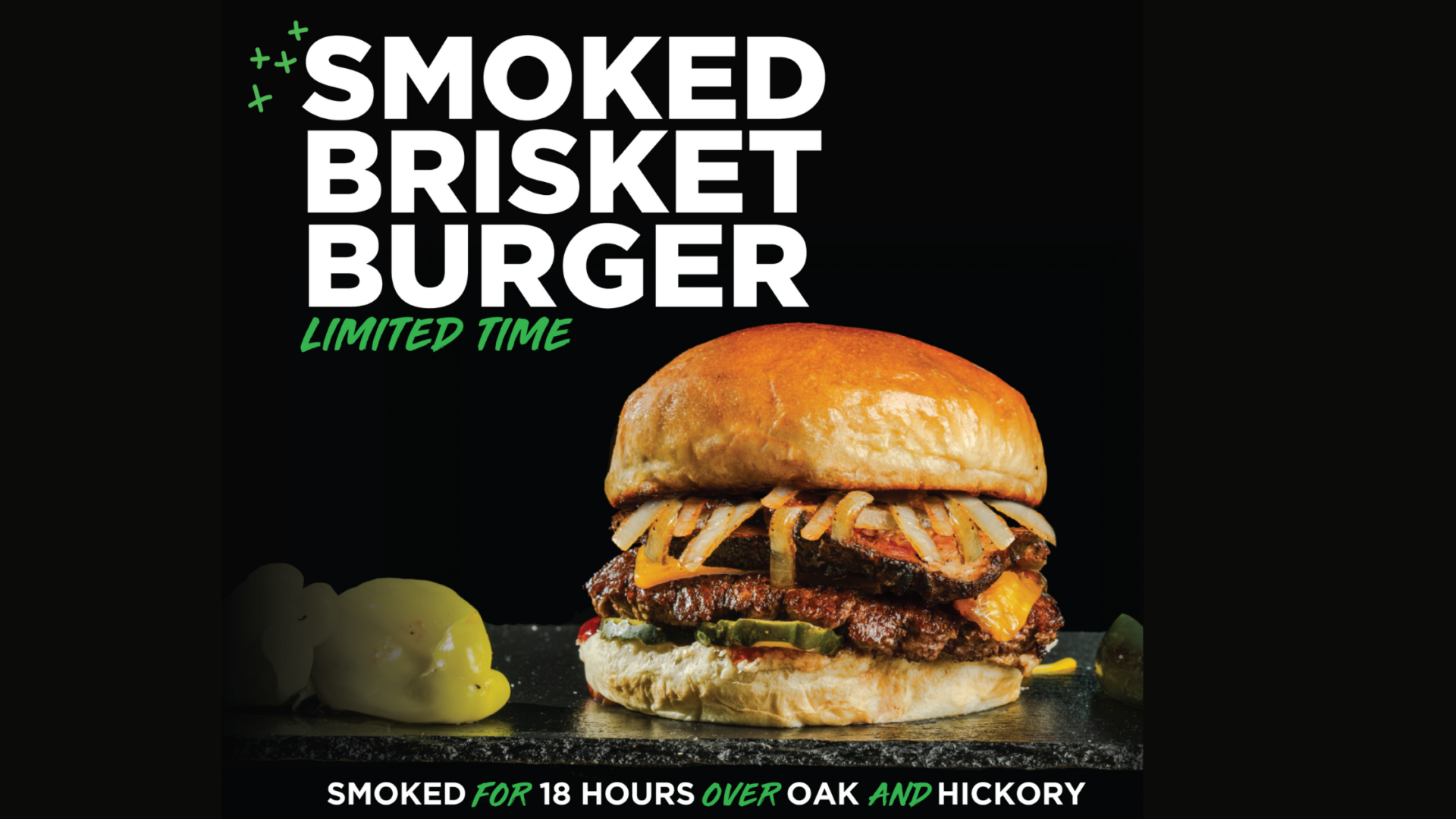 Words saying "Smoked Brisket Burger, Limited Time. Smoked in oak and hickory for 18 hours. Image of burger with white bun, grilled onions, brisket, grassfed beef, cheese and pickles with a side of pepperchini and jalapeños